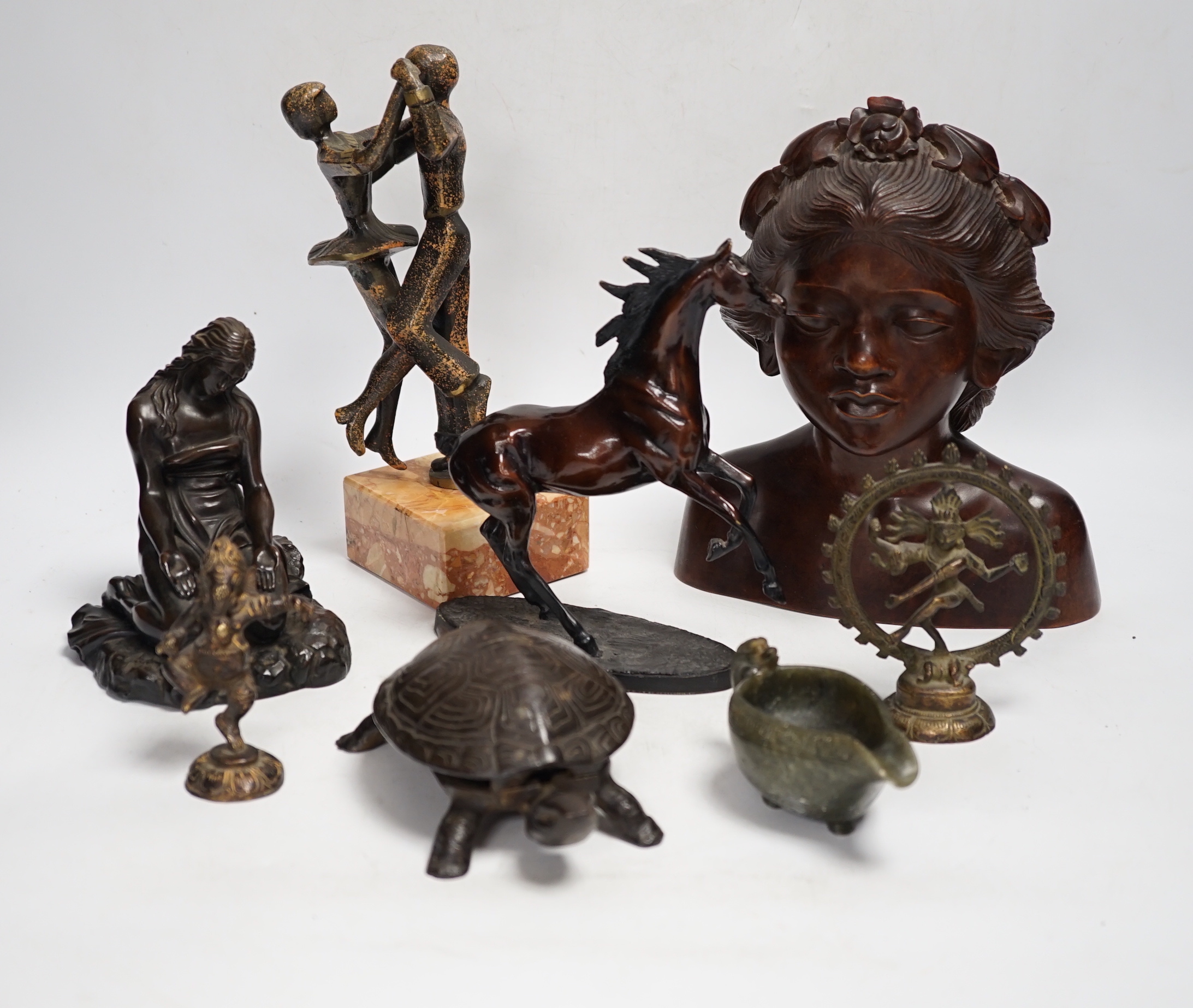 Mixed metal and carved ornaments, including a tortoise table bell, a statue of two dancers and a Balanese head, etc, 22cm